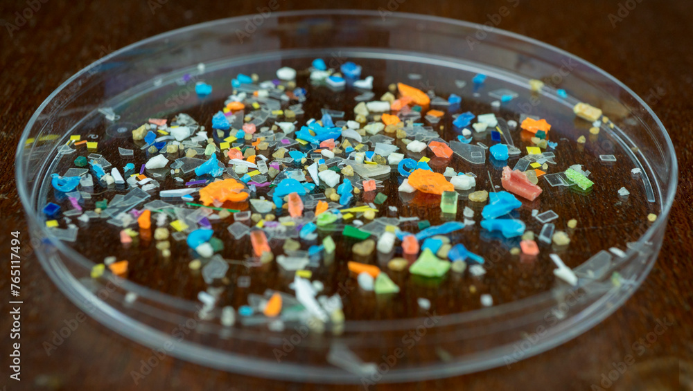 Macro shot of microplastics composition inside a lab petri dish. Concept of plastic pollution with nanoplastics. Detail of micro plastic particles that cannot be recycled.