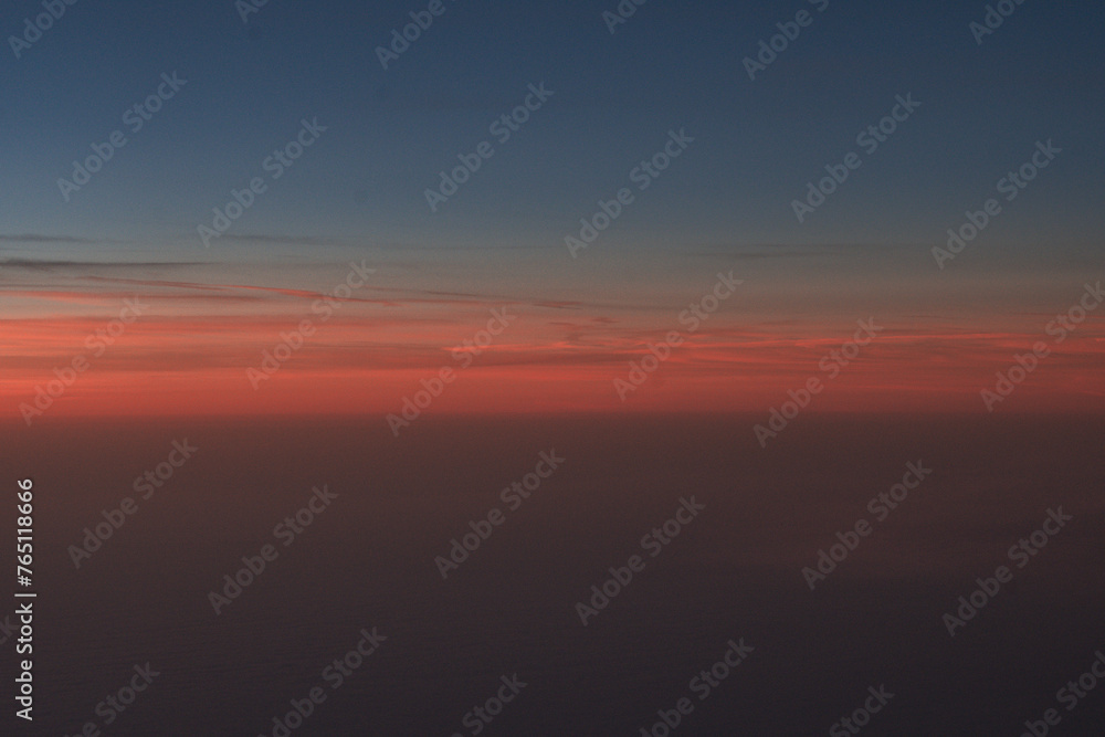 Aerial view of the sunrise above the clouds outside of my airplane window on a flight from Richmond to Houston 