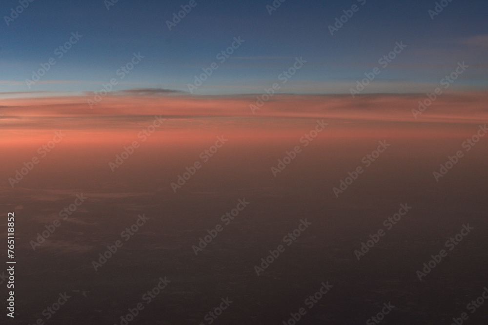 Aerial view of the sunrise above the clouds outside of my airplane window on a flight from Richmond to Houston 