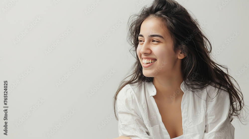An image of a happy Woman in white clothes on a white background and Looking at the Camera. An image of a happy Woman in white clothes on a white background and Looking at the Camera.
