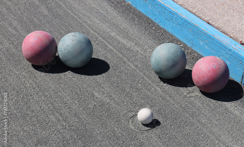 Bocce balls lined up on the court after being thrown in a game