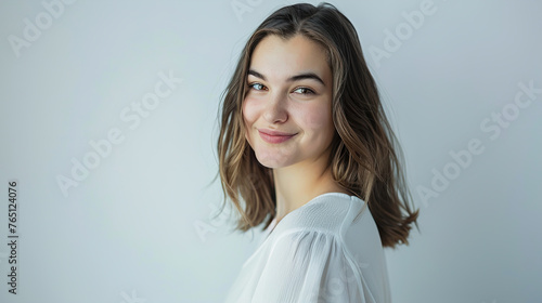 An image of a happy Woman in white clothes on a white background and Looking at the Camera.