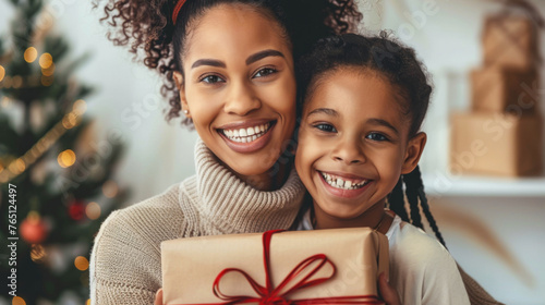 Mother and daughter smiling with Christmas gift