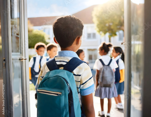 Young Boy With Backpack Facing School Gates on a Sunny Morning