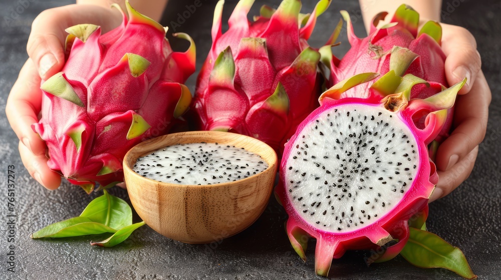 a close up of a dragon fruit next to a bowl of fruit and a person's hands holding a piece of fruit. a close up of a dragon fruit next to a bowl of fruit and a person's hands holding a piece of fruit.