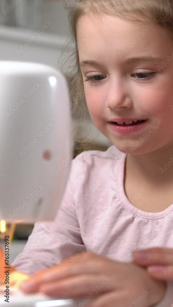 Mother teaching her little daughter to sew using a sewing machine in the nursery at home. Children's craft, education and training. Vertical video for smartphone screen, for target social media Mother teaching her little daughter to sew using a sewing machine in the nursery at home. Children's craft, education and training. Vertical video for smartphone screen, for target social media