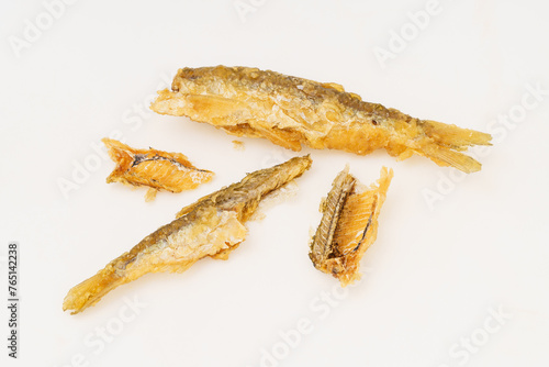 Fried small river fish on white background