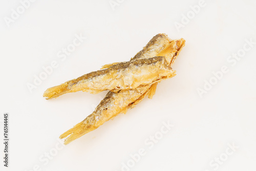 Fried small river fish on white background