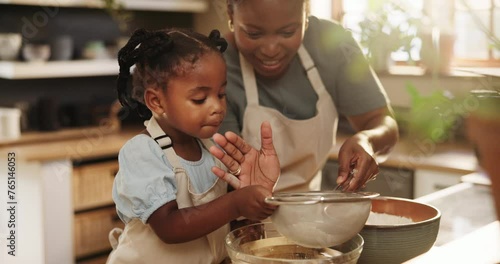 Mommy, daughter and flour for baking pastry in kitchen, education and learning for child development. Black family, home and love for cookie or cake, cooking and support while bonding on weekend photo