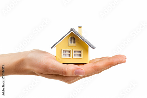 Small house on the palm of your hand on a white background. The concept of mortgage, housing for a young family, increase in utility bills