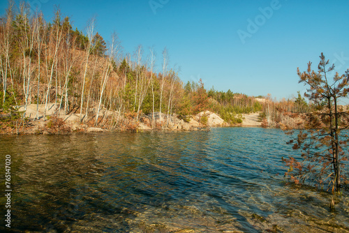 flooded quarry and forest on the shore