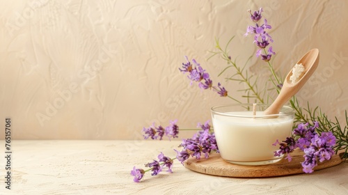 a bottle of milk and a wooden spoon on a table with purple flowers and a wall in the back ground.