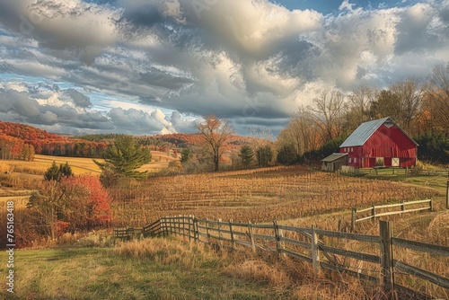 A red barn standing tall next to a wooden fence on a farm