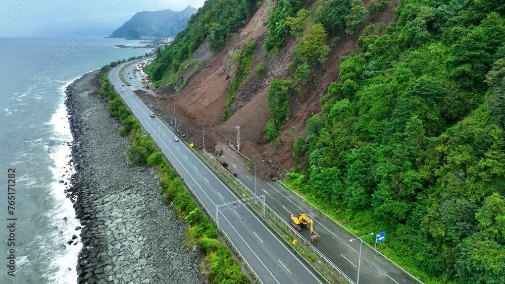 Mountain soil collapse in half of the highway. Landslides due to heavy rainfall. Rockslide over road. Dangerous Landslide, natural disaster led to roadblock. Climate change, warming, desertification Mountain soil collapse in half of the highway. Landslides due to heavy rainfall. Rockslide over road. Dangerous Landslide, natural disaster led to roadblock. Climate change, warming, desertification