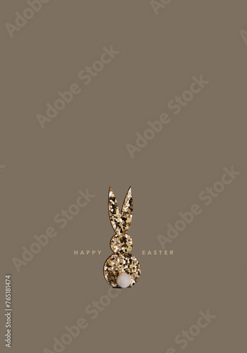 Gold glitter bunny, with "happy easter" lettering, beige background © SONJA