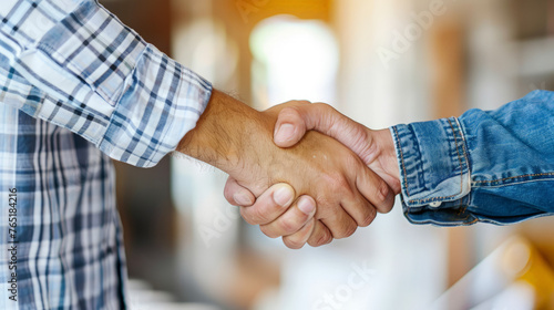 Construction job seeker shaking firm hand with his new employer both in professional attire. © Bnetto