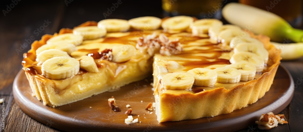 Pie with sliced bananas and nuts on wooden plate Pie with sliced bananas and nuts on wooden plate