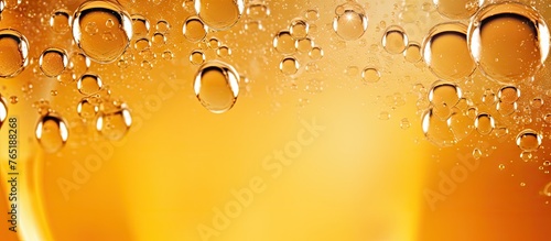 Close-up of frothy beer glass with bubbles photo