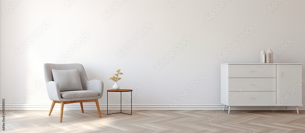 Room with white wall featuring chair and table Room with white wall featuring chair and table