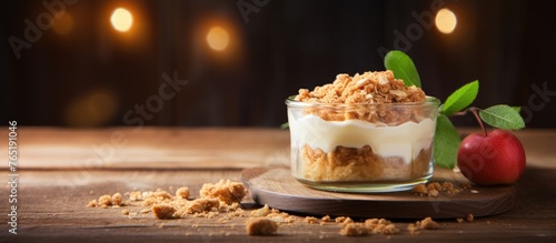 Apple crumble dessert served in a glass with a cherry on top photo