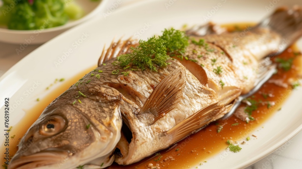Fish with sauce on a white plate, close-up, horizontal