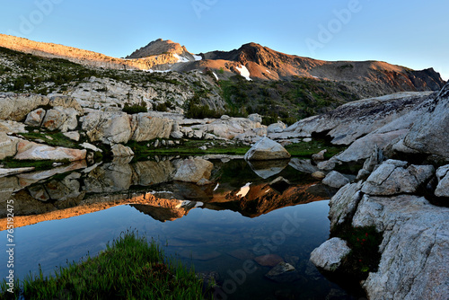 Sierra Nevada Mountains reflected in Cascade Lakes on a calm summer morning.