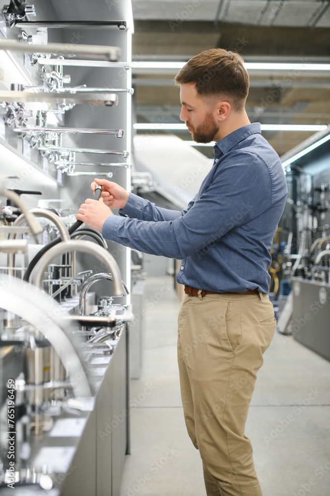 Man chooses a products in a sanitary ware store Man chooses a products in a sanitary ware store