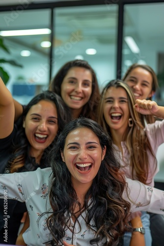 group of smiling business women celebrating happily