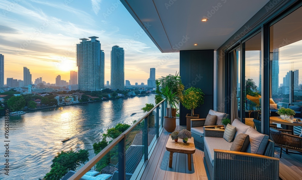Fototapeta premium Modern balcony with comfortable chairs at sunset, city skyline background