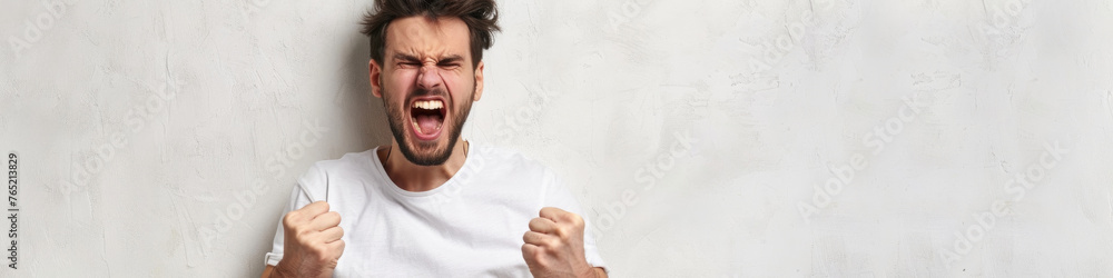 A man stands with his mouth open and hands raised in the air A man stands with his mouth open and hands raised in the air