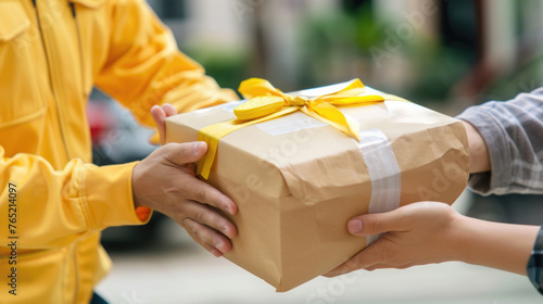 A person is giving a wrapped present to another individual in a simple and heartfelt gesture
