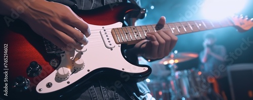 Close up musician playing electric guitar on a concert stage