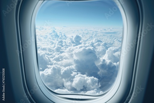 Clouds and sky as seen through window of an aircraft photo