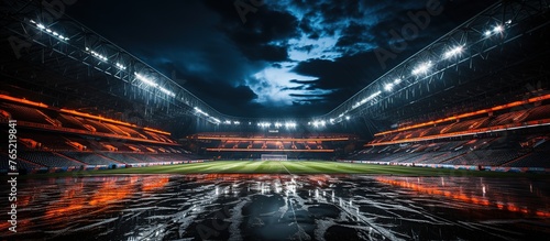 Empty soccer stadium at night with reflection in water.