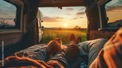a person and a cat are laying in the back of a van at sunset. Generative AI