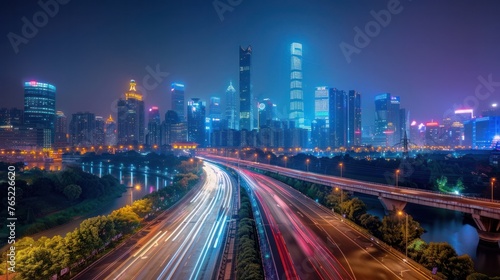 In Guangzhou, China, there is a modern city skyline and an asphalt road illuminated at night.