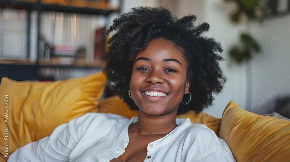 Fototapeta premium Smiling Young Woman Relaxing on Couch in Her New Home, Happy Portrait, Lifestyle Photography