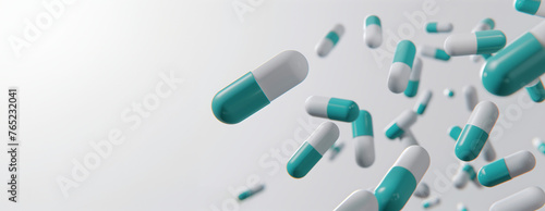 Teal and white pills fallen on a white background. Dynamic pharmaceutical concept. Design for medical banner with copy space, health supplement advertisement, pharmacy brochure.