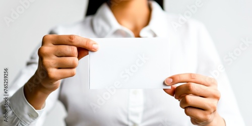 A woman holding a blank piece of paper in her hands