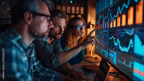Analytical Team Engrossed in Financial Forecasting. In a dimly lit room, a team of analysts intensely scrutinizes financial forecasts and market trends on advanced digital screens.