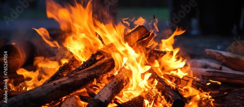 A detailed view of a fiery blaze with plenty of wood logs feeding the flames