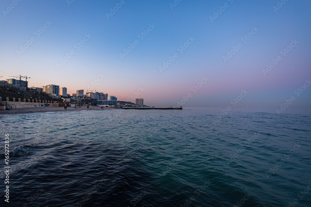 Sunset on the shore of the city beach