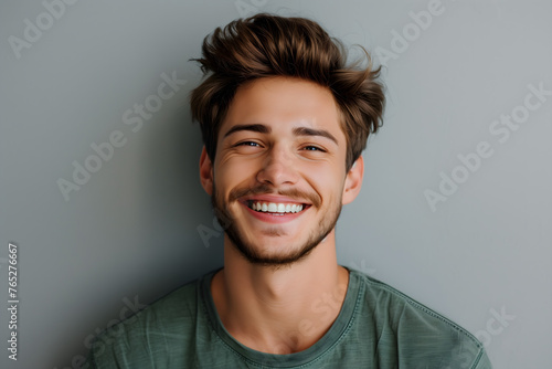 Confident young man with charming smile on clean background. Positive human expressions