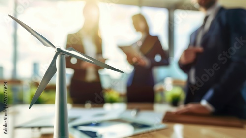 Unfocused investors and technicians in the foreground are talking about generating electricity from wind turbines. Wind farms are an alternative source of electrical energy.