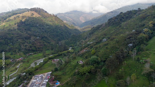 Aerial view of the green mountains and the river in the municipality of Pijao, Quindío, Colombia. Pijao, city without rush