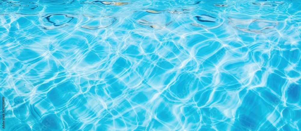 A closeup shot capturing the azure liquid pattern of the electric blue water in a swimming pool, creating a mesmerizing fluid and windy wave font