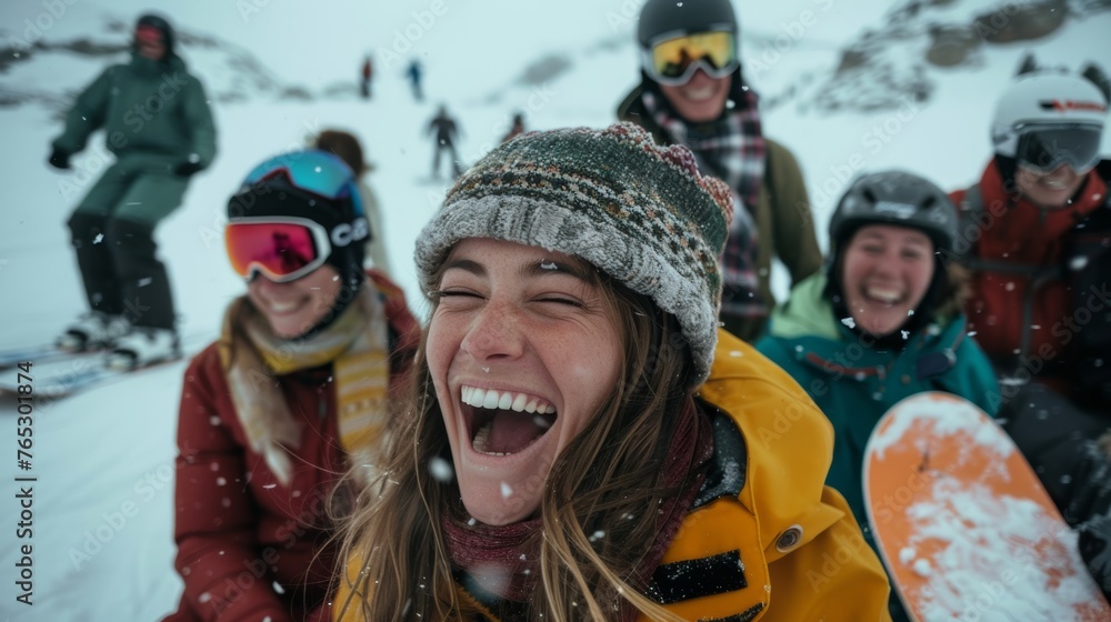A woman snowboarder laughing with her friends amidst a group portrait on a snowy mountain vacation A woman snowboarder laughing with her friends amidst a group portrait on a snowy mountain vacation