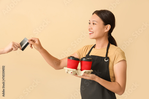 Female Asian barista with c...