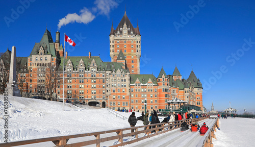 Traditional slide ride in winter in Quebec City with Frontenac Castle on the background, Canada