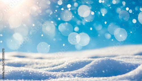 winter snow background with snowdrifts with beautiful light and snow flakes on the blue sky beautiful bokeh circles banner format copy space © Francesco
